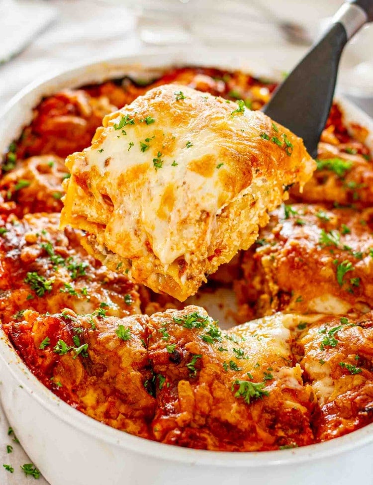 a beef lasagna in a white casserole dish.