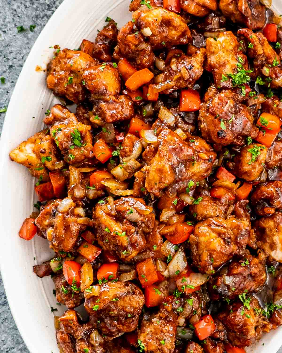 black pepper chicken in a white serving platter.