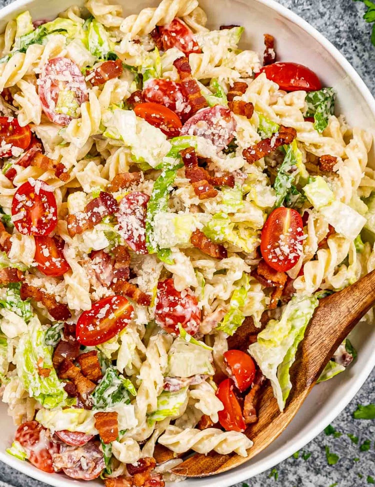 freshly made blt pasta salad in a white pasta bowl.