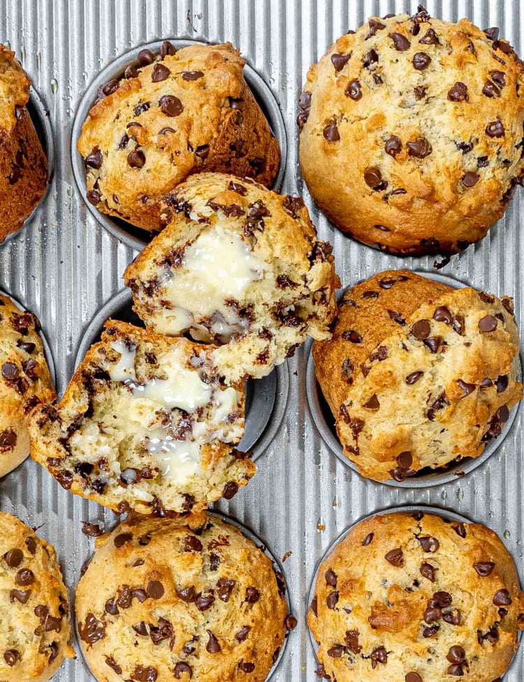freshly baked chocolate chip muffins in a muffin pan.
