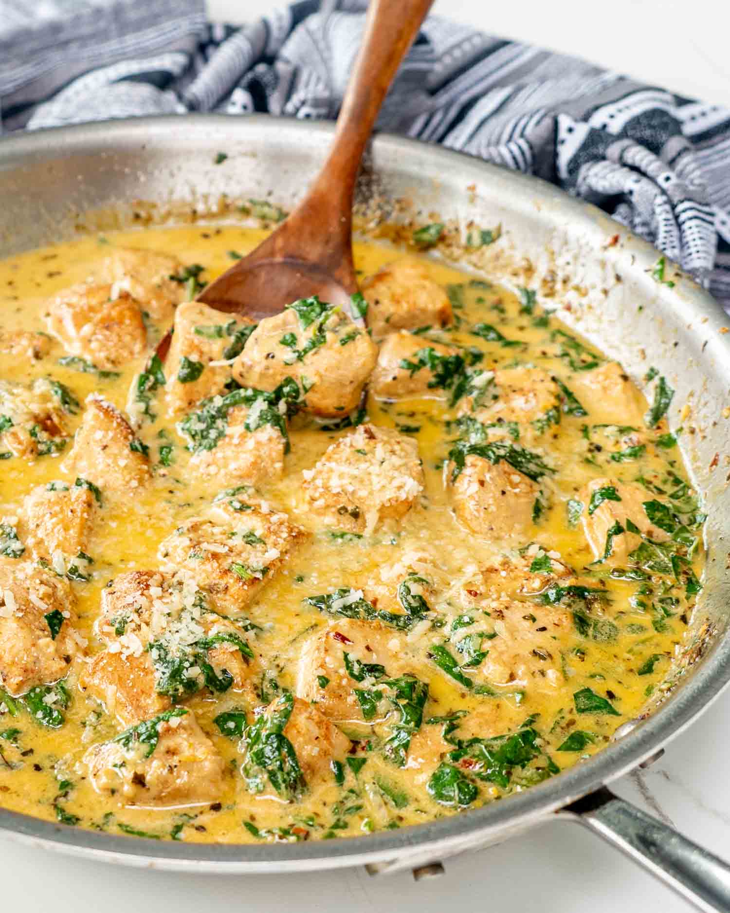 freshly made creamy butter lemon chicken in a stainless skillet.