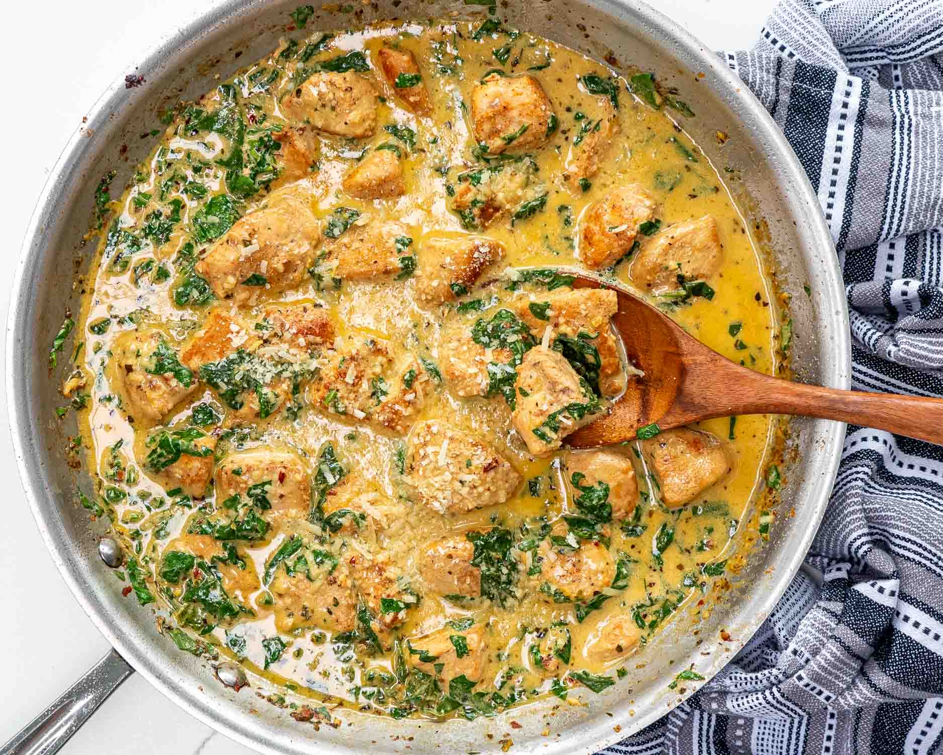 freshly made creamy butter lemon chicken in a stainless skillet.