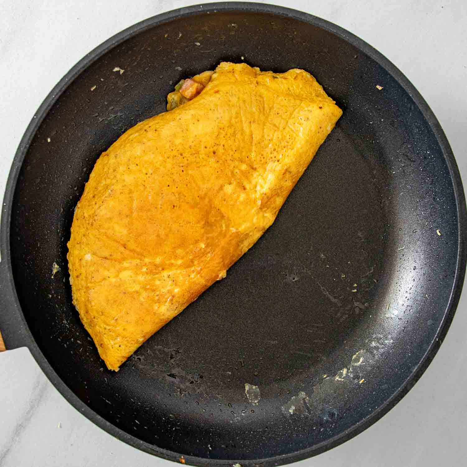 process shots showing how to make a denver omelette.