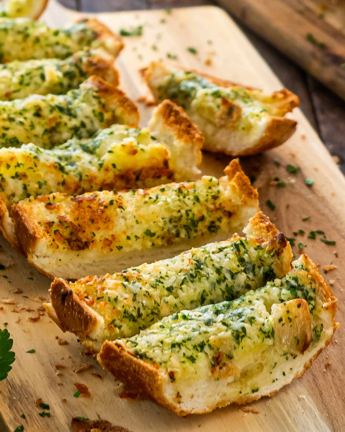 garlic bread freshly baked on a cutting board sliced.