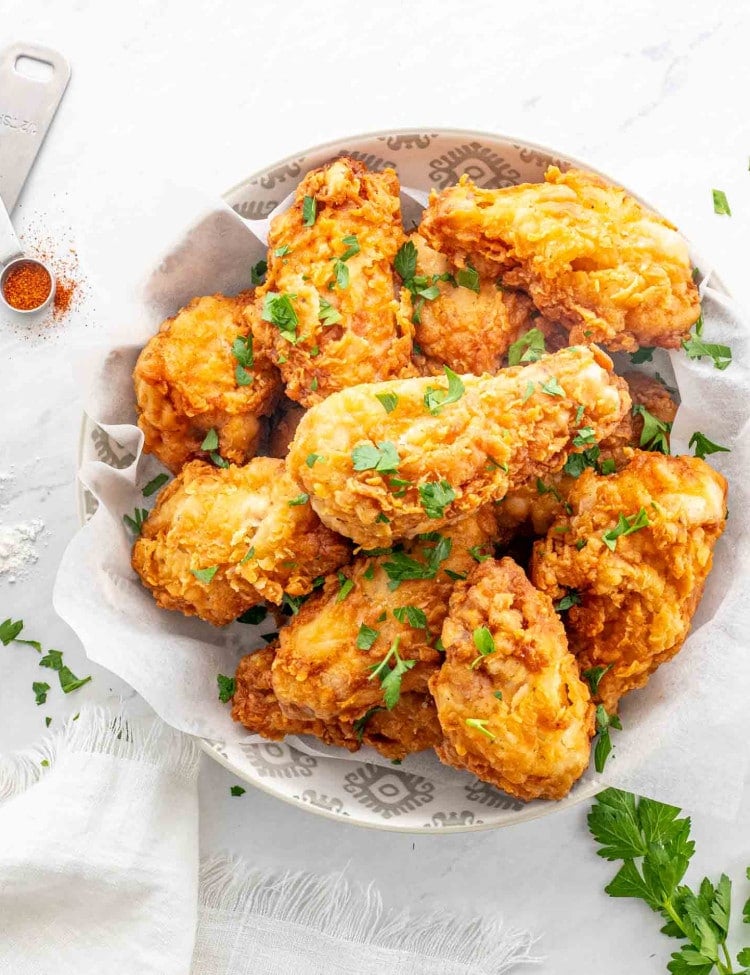 a bowl with crispy and delicious buttermilk fried chicken.
