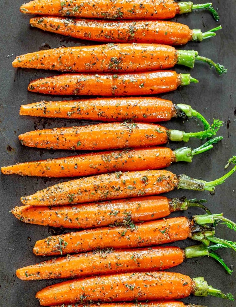 garlic herb carrots on a baking sheet ready to go in the oven.