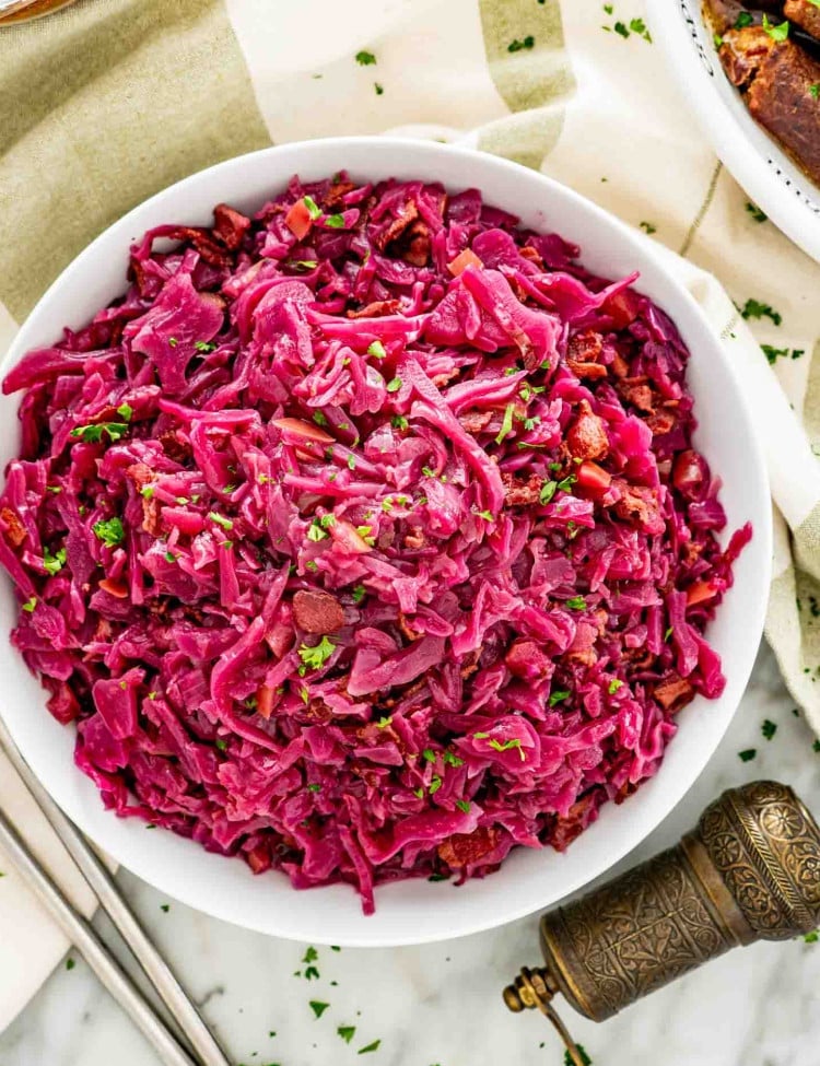 a big white bowl filled with freshly made german red cabbage.
