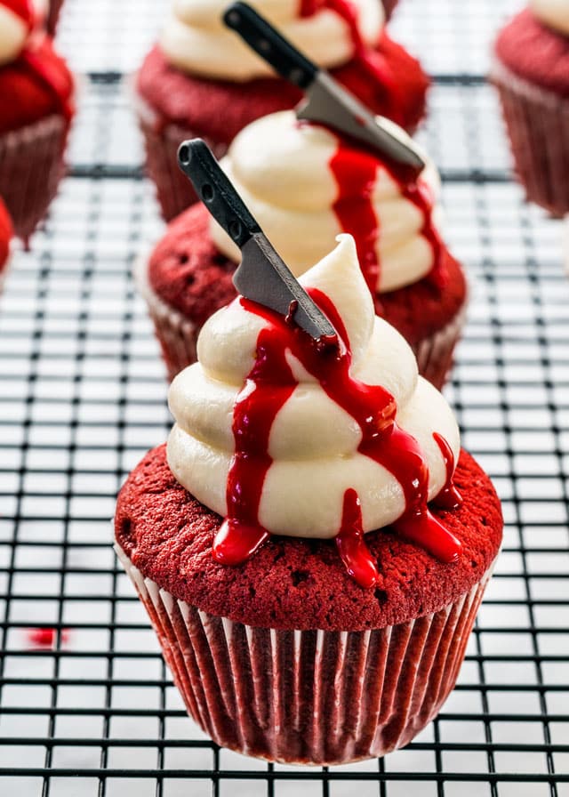 side view shot oh halloween red velvet cupcakes on a cooling rack