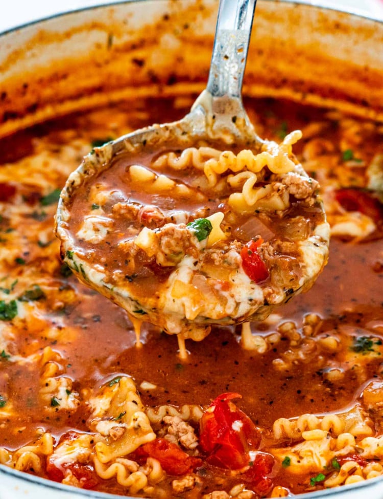 lasagna soup in a dutch oven with a ladle inside.