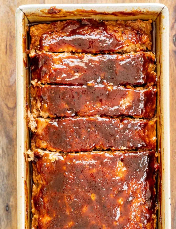 a sliced meatloaf in a loaf pan.