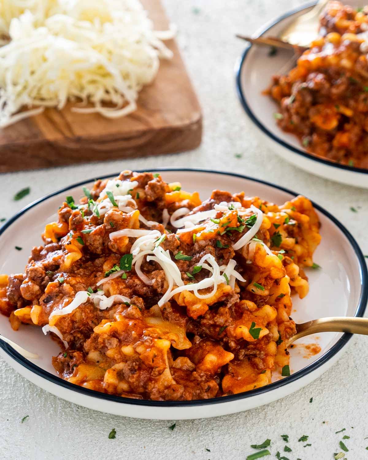 a serving of hamburger helper lasagna in a white plate.