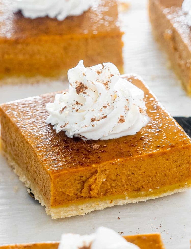 a spatula holding a pumpkin pie bar.