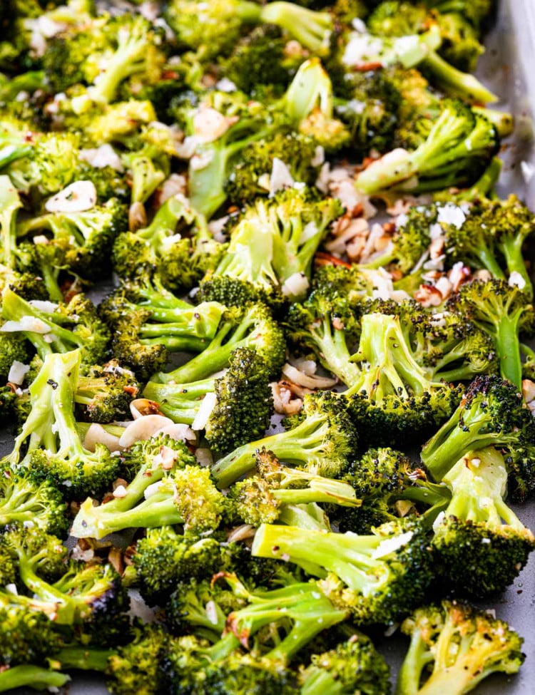 closeup of roasted broccoli on a baking sheet.
