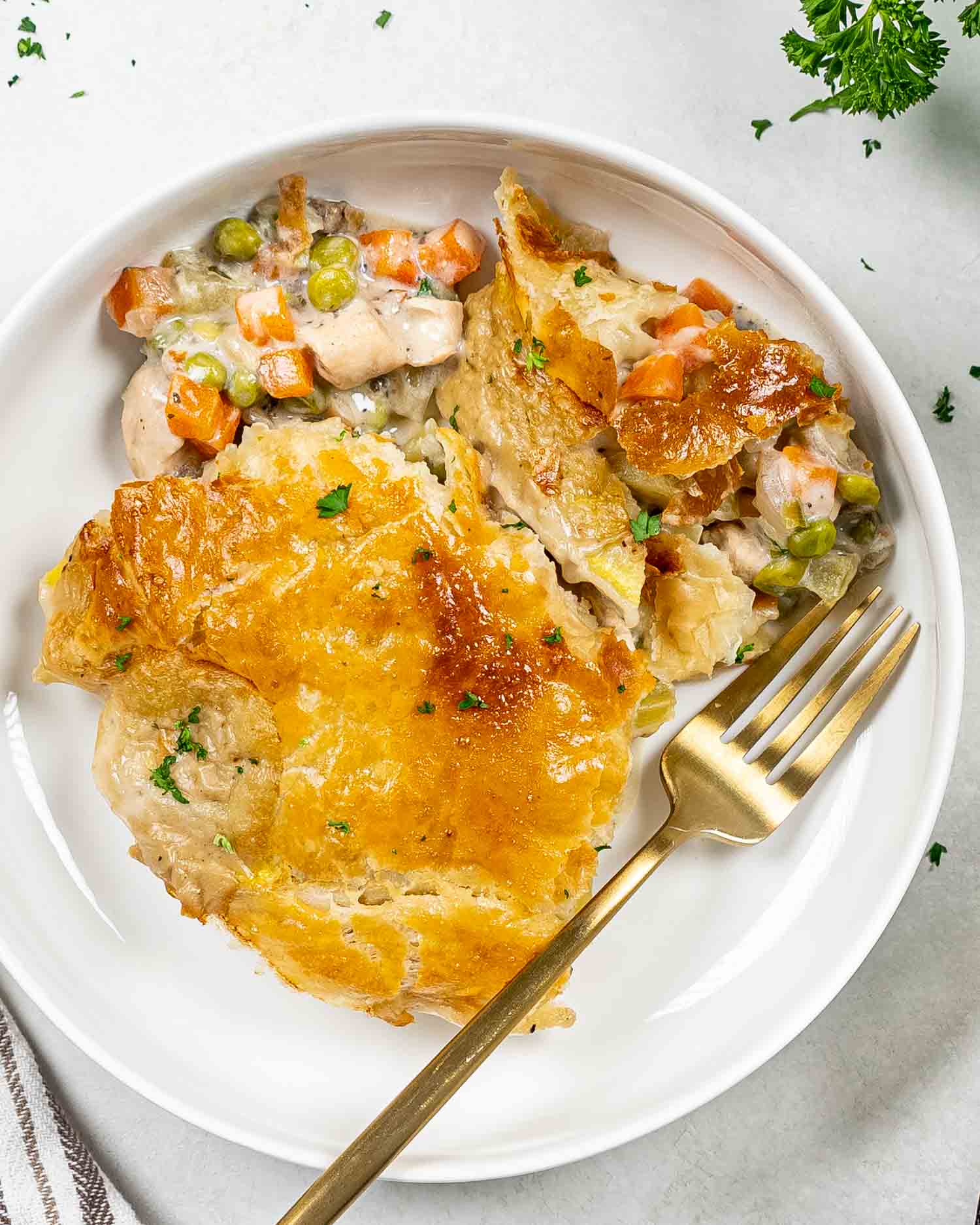 a serving of chicken pot pie in a white bowl.