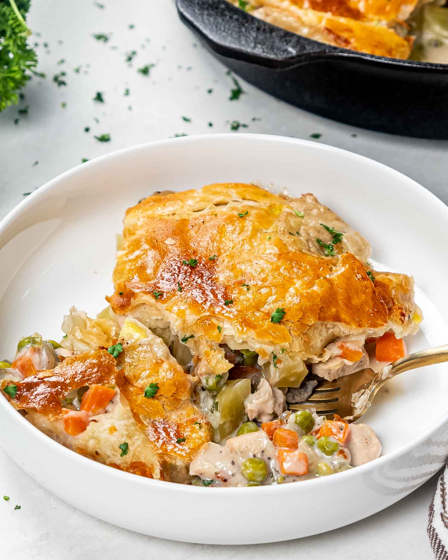 a serving of chicken pot pie in a white bowl.