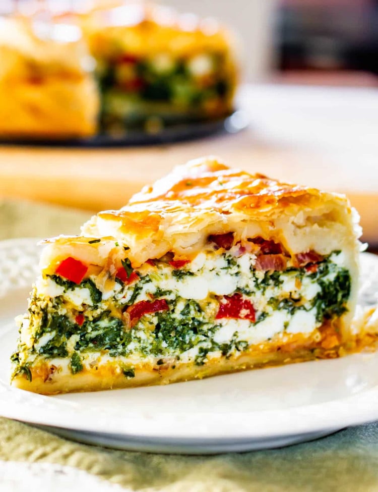 side view shot of a plate with a slice of spinach ricotta brunch bake on it